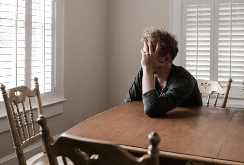 A depressed man thinking about starting an online depression treatment