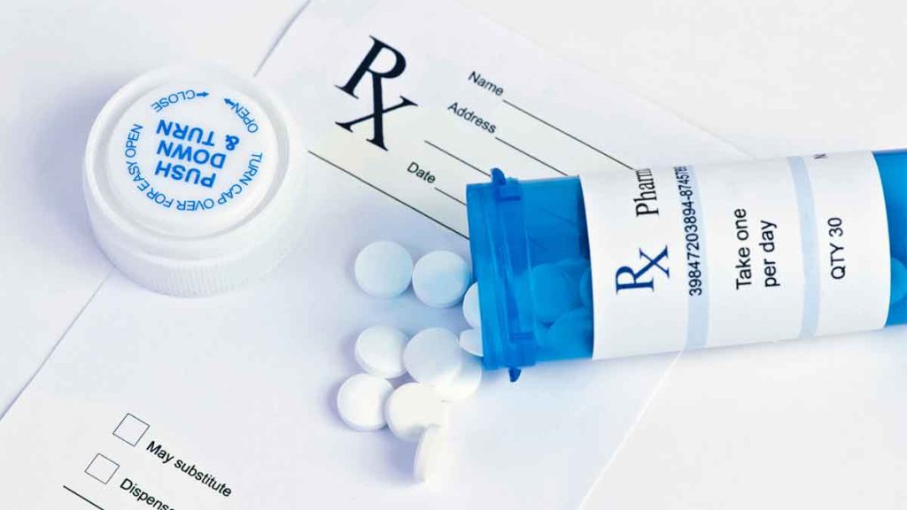 Open prescription bottle with white pills and an RX form.