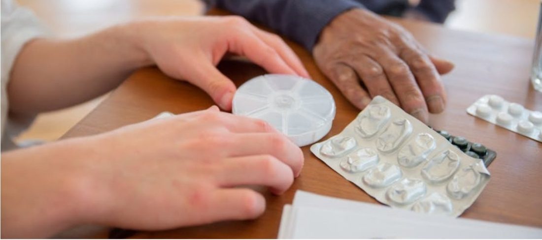Two people preparing medications