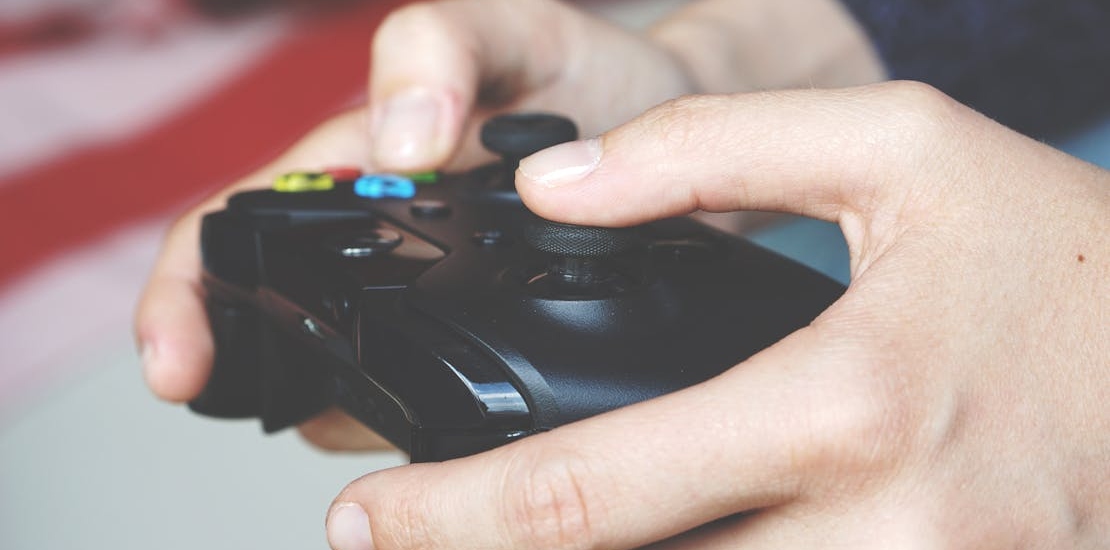 man Holding Black Game Controller
