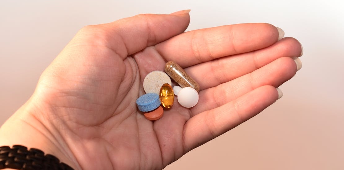 a person holding pills