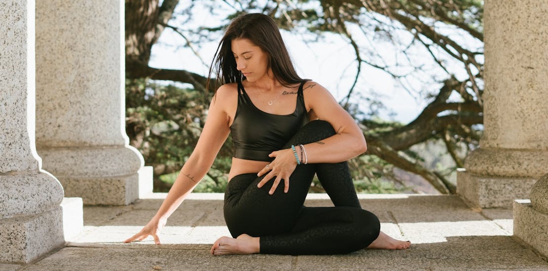 a woman doing yoga embracing the benefits of exercise on mental health