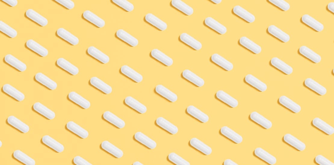 white pills on a yellow surface