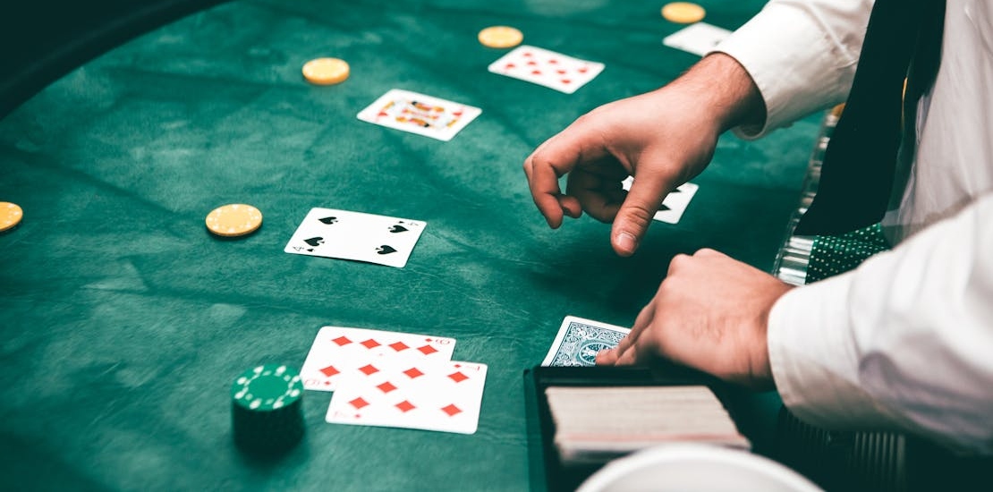 a man playing cards which are one of the most addictive types of gambling