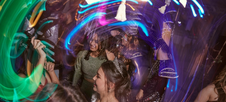 People dancing in nightclub while experiencing pink cocaine effects.